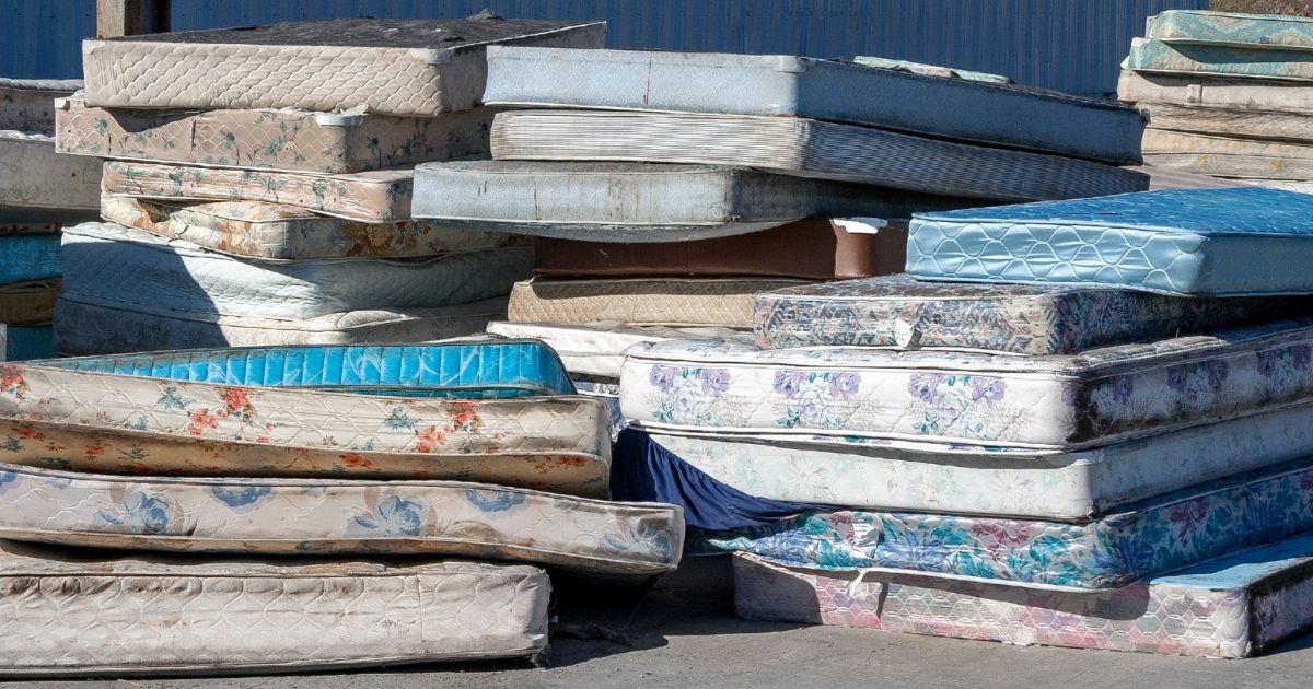 pile of old mattresses that need proper disposal